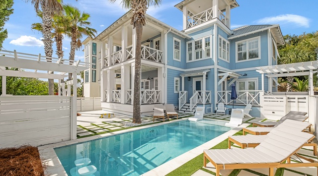 Elegant coastal architecture with pristine swimming pool and tropical landscaping in a tranquil setting.