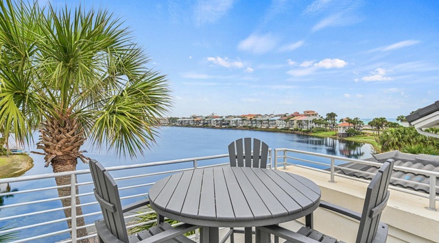 Enjoy waterfront dining on your private balcony with stunning lake views and tropical palm trees creating the perfect breakfast backdrop.