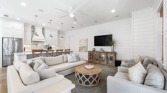 Relax in your bright, coastal-inspired living space with plush seating and open kitchen perfect for group gatherings.