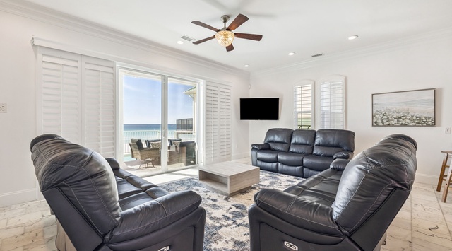Sink into plush leather recliners while your ceiling fan whispers overhead, creating the perfect spot to unwind after beach days.