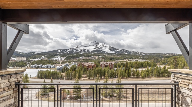 Your private balcony opens to breathtaking mountain views, where snow-capped peaks frame the valley below in alpine splendor.