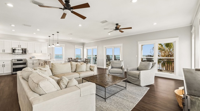 Sink into plush seating as coastal breezes drift through your open-concept living space, where sunlight and ocean views fill every corner with warmth and tranquility.