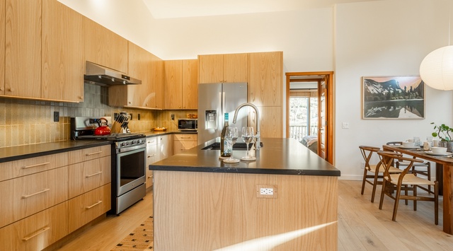 You'll love cooking in this beautifully designed kitchen with warm wood cabinets, sleek countertops, and modern appliances.