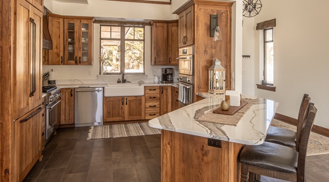 Your gourmet kitchen awaits with rich wood cabinetry, marble countertops, and top-tier appliances for memorable culinary moments.