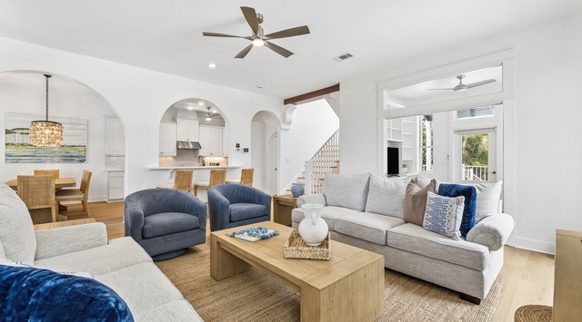 Step into your coastal retreat where high ceilings and elegant archways create an airy flow between your spacious living area, dining space, and gourmet kitchen—perfect for relaxing or gathering with loved ones.