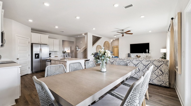 Gather around your spacious dining table where memorable meals and conversations unfold in this bright, modern open-concept space.