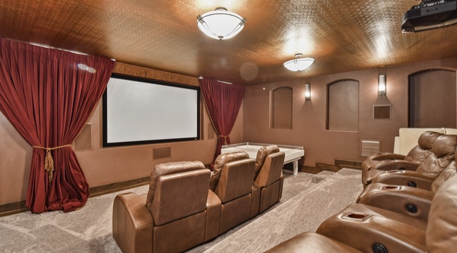 Settle into plush leather recliners and enjoy a private movie night in your own luxurious home theater, complete with a big screen and rich, elegant decor.