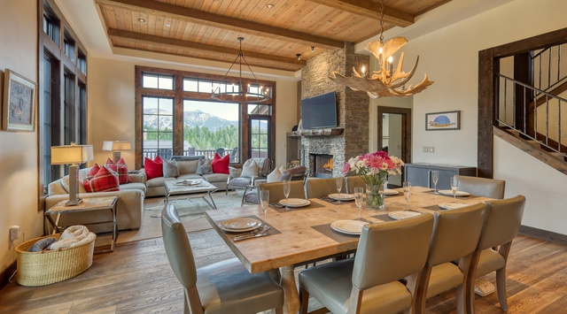 Gather around your rustic dining table while the fireplace crackles and mountain views frame every meal in this stunning great room.