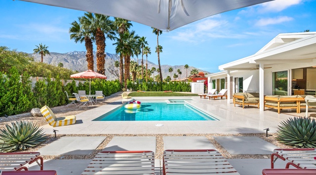 Dive into your private oasis where desert mountains frame crystal-clear waters and poolside loungers await your perfect vacation moments.