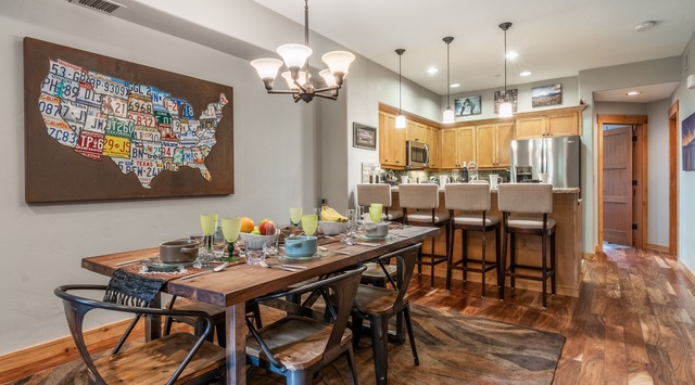 Gather around the spacious dining table where your mornings start with fresh coffee and your evenings with shared meals and laughter beneath warm pendant lighting.