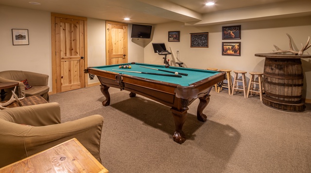 Challenge friends to pool in your private game room, complete with rustic seating and mountain lodge charm.