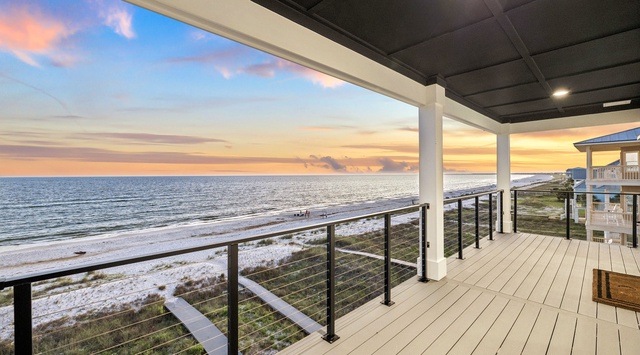 Expansive beachfront balcony offers panoramic Gulf views, a covered lounge area, and direct access to soft white sands—your peaceful coastal escape awaits.