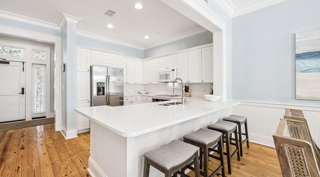 Your gourmet kitchen awaits with gleaming quartz counters, professional appliances, and a spacious island perfect for morning coffee or evening gatherings.