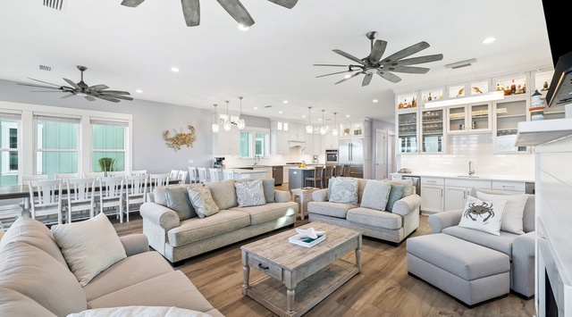Unwind in your spacious open-concept living area with coastal vibes, plush seating, and a gourmet kitchen ready for memorable meals together.
