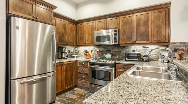 Step into your fully equipped kitchen with granite counters, stainless appliances, and charming wood cabinetry—everything you need to prepare a delicious home-cooked meal.
