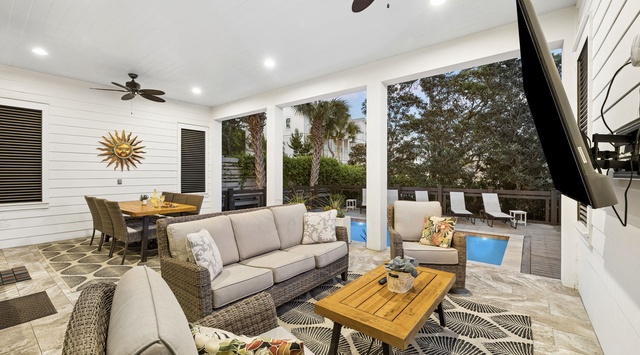 Sink into plush outdoor seating under ceiling fans and feel the breeze, with tropical views of your private pool and lush surroundings just steps away.