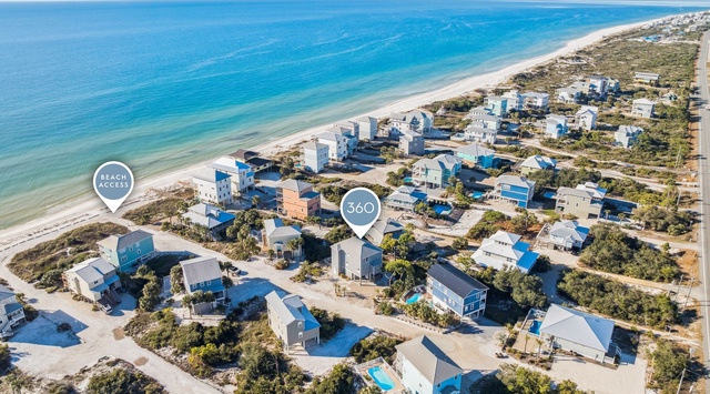 Beachfront community with vacation homes nestled between pristine coastline and natural dunes, offering direct beach access.