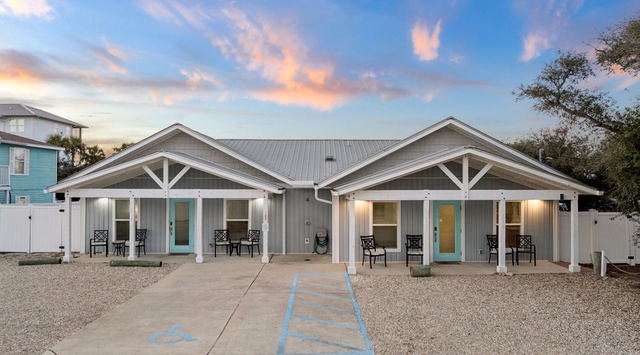 Modern duplex vacation rental with charming coastal architecture and convenient parking, perfectly positioned for your getaway.