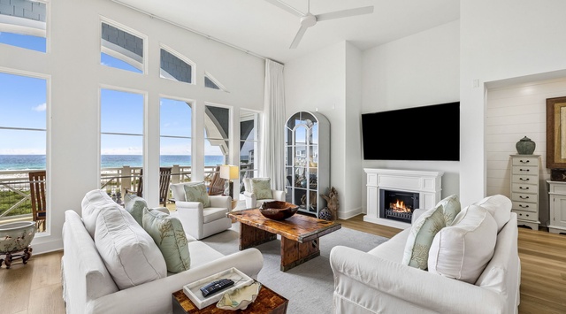 Sink into plush seating and soak in sweeping ocean views through floor-to-ceiling windows. Your coastal retreat awaits with a cozy fireplace, elegant furnishings, and the calming rhythm of the waves just beyond your private deck.
