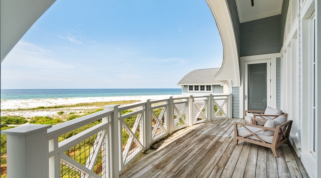 Step onto your private oceanfront balcony and soak in stunning beach views while relaxing in comfortable seating.