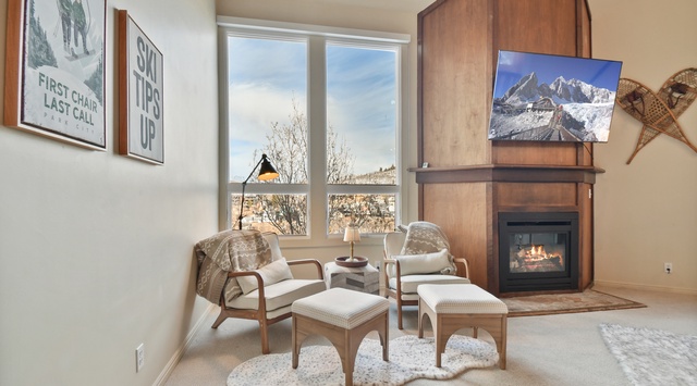 Sink into cozy chairs by your crackling fireplace while mountain views fill the windows—perfect for après-ski relaxation.