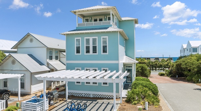 Charming coastal vacation home with beachside access, bicycles for exploration, and spacious outdoor entertaining area near the shore.