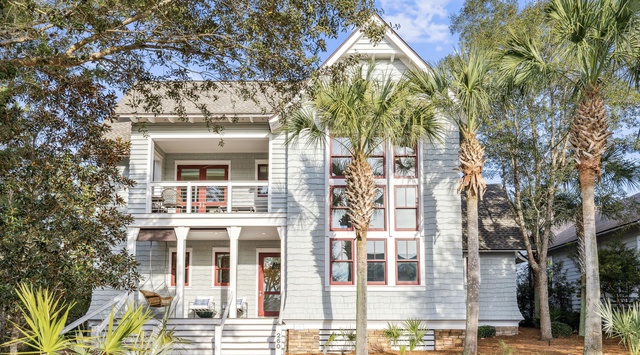 Charming coastal retreat with classic architecture and tropical landscaping creates the perfect vacation setting.