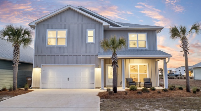 Modern coastal home with beautiful architecture and palm trees, capturing the essence of beachside living.
