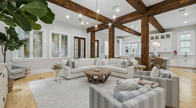 Settle into this inviting open-concept living space, where rustic exposed beams meet modern comfort. Sink into plush seating and enjoy the seamless flow into your fully-equipped kitchen—perfect for relaxing evenings or hosting memorable gatherings.