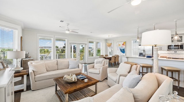 Settle into the soft, coastal comfort of this open living space where natural light spills through every window, inviting you to relax and make yourself at home.