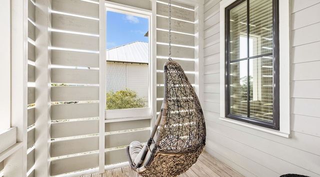 Curl up in your private hanging chair on this cozy covered porch—a perfect spot to sip morning coffee or unwind with a book while enjoying the fresh air and peaceful surroundings.