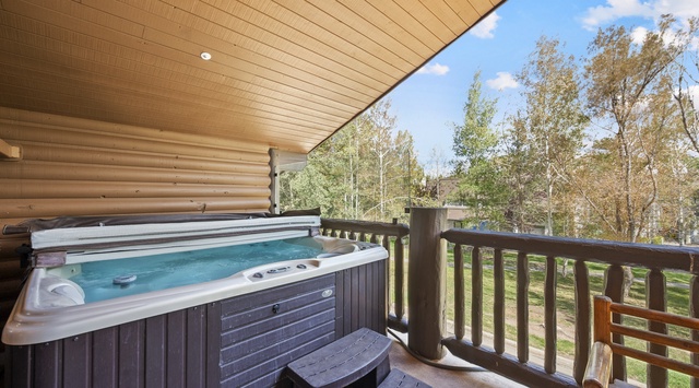 Slip into your private hot tub and let the warmth soothe you as you take in the peaceful wooded surroundings from your covered terrace.