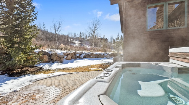 Soak in your private hot tub while enjoying stunning mountain views and crisp winter air—pure alpine relaxation awaits.