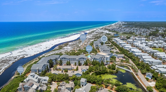 Aerial view of beachfront community with pristine white sand beaches and emerald waters along the Gulf Coast.