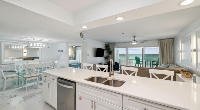 Your open kitchen flows seamlessly into the dining and living areas, with stunning ocean views creating the perfect backdrop for your coastal getaway.