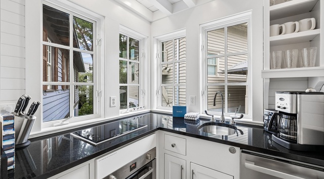 Your bright, modern kitchen features sleek granite counters, quality appliances, and abundant natural light flooding through large windows—perfect for preparing meals or sipping your morning coffee.