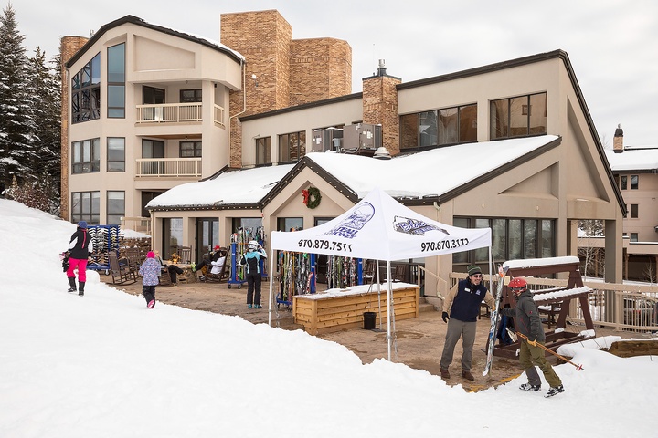 A premier ski-in/ski-out property nestled in a winter resort village, featuring direct slope access, on-site rental shop, and festive alpine architecture surrounded by pristine snow.