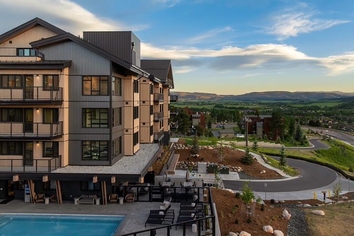 Modern mountain retreat set against rolling hills and open valleys, offering a peaceful escape with outdoor pool and spacious grounds for relaxation.