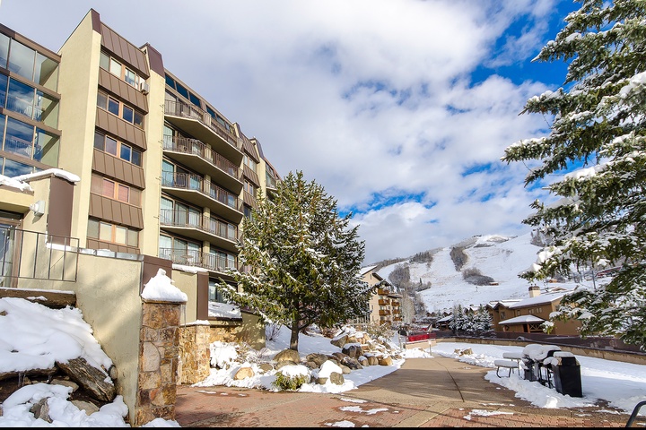 The property nestled in a scenic alpine ski village, surrounded by snowy slopes and mountain views, offers a perfect winter retreat location.