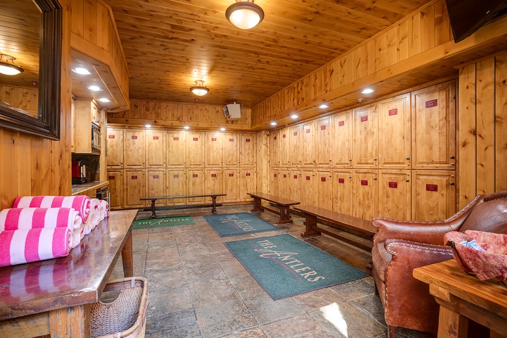 Your own private ski locker room with secure storage, plush seating, and warm wood throughout—everything you need to gear up in comfort.