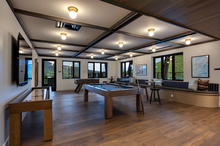 Your private game room awaits with stunning mountain views—challenge friends to billiards or shuffleboard while soaking in the natural beauty through every window.
