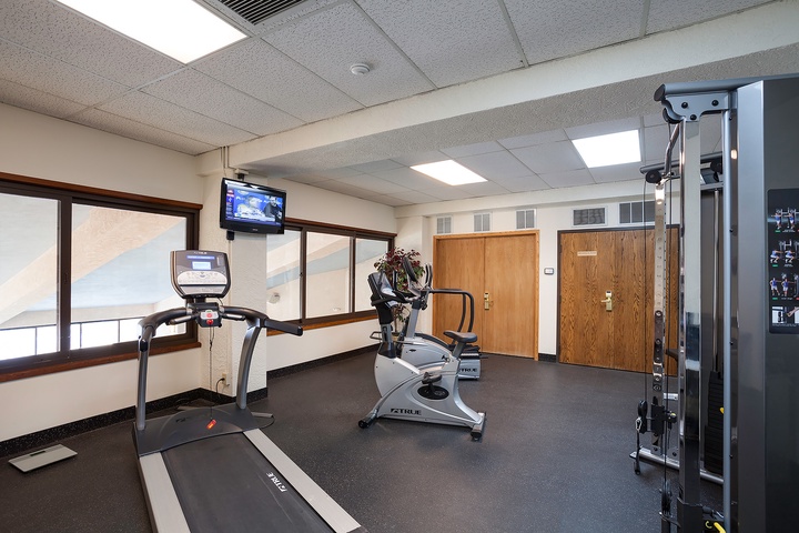 Stay active during your getaway in this well-equipped fitness center featuring cardio machines, strength training equipment, and natural light to energize your workouts.