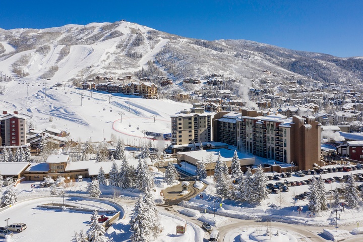 Nestled at the base of snow-covered ski slopes, this mountain resort offers winter access to trails, lifts, and alpine village charm.