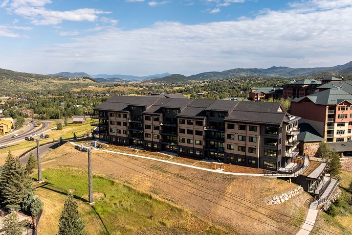 An elevated view captures the property's mountain surroundings and the neighborhood's scenic setting amid rolling hills and expansive skies.