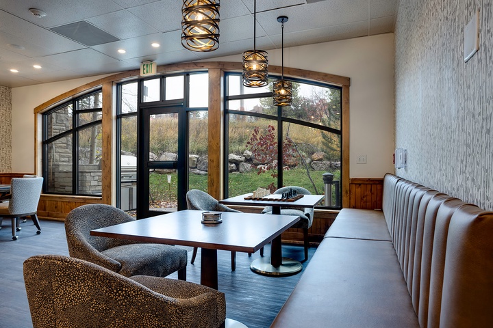 Relax in the communal lounge where modern style meets natural warmth. Sink into plush seating beneath sculptural lighting as garden views pour through arched windows, creating your perfect retreat.