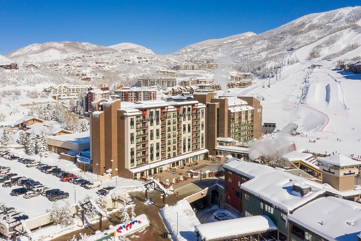 A premier ski resort nestled in snow-covered mountains, featuring slopeside lodging, base facilities, and direct access to groomed runs and lifts.