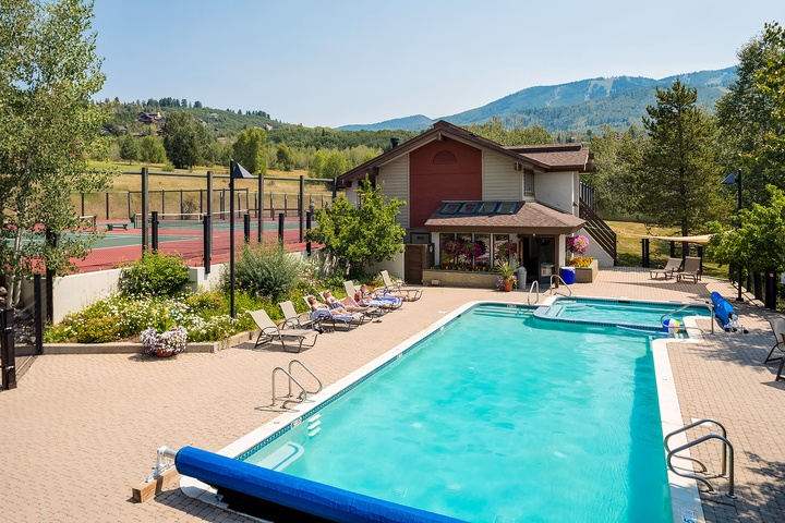 The property features a sparkling outdoor pool, tennis court, and mountain views set within beautifully landscaped grounds ideal for relaxing getaways.