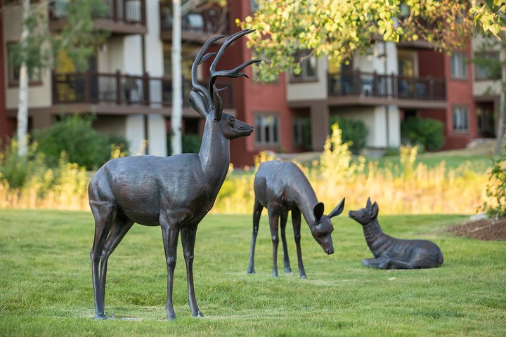 Striking sculptures grace the property's landscaped grounds, showcasing artistic details and creating a unique character in the surrounding neighborhood.