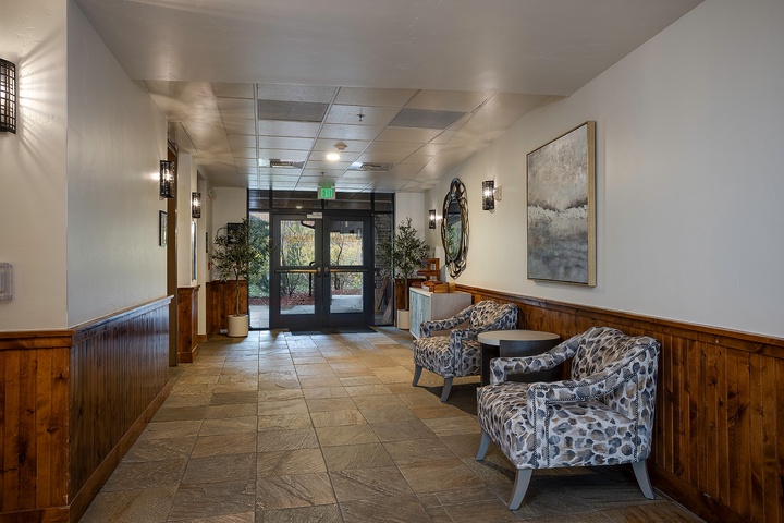 The property's welcoming entrance lobby features modern furnishings and natural light, with warm wood accents and tasteful artwork setting a comfortable tone for your mountain getaway.