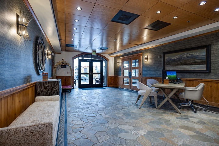 Step into a welcoming lobby where rustic wood accents meet contemporary design. Relax in the inviting seating area or catch up on work at the convenient desk—your mountain retreat starts here.